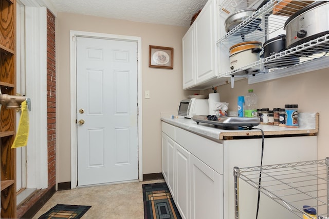 laundry area with a textured ceiling