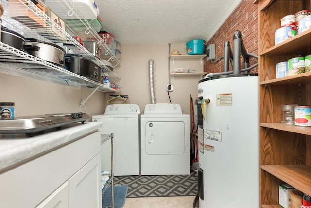 laundry area featuring separate washer and dryer, water heater, brick wall, and a textured ceiling