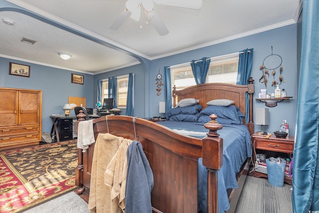 bedroom with ceiling fan, crown molding, and carpet floors