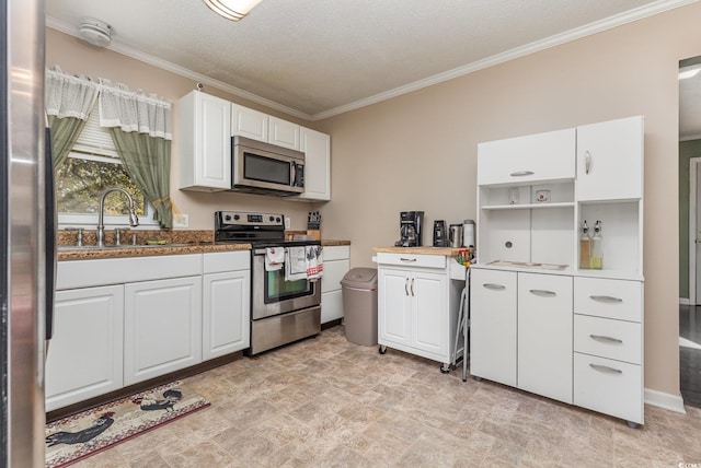 kitchen featuring a textured ceiling, stainless steel appliances, crown molding, sink, and white cabinetry