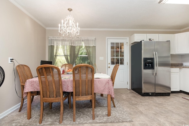 dining room with ornamental molding and a notable chandelier