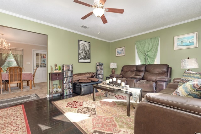 living room with hardwood / wood-style floors, ceiling fan with notable chandelier, a textured ceiling, and crown molding