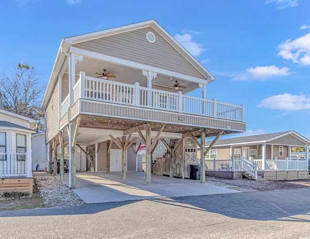 view of front of home featuring ceiling fan, a carport, and covered porch