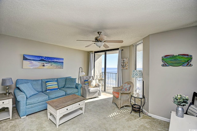 3601 S Ocean Blvd Unit 7-E, North Myrtle Beach, SC 29582 - carpeted living room with ceiling fan, a textured ceiling, and a water view