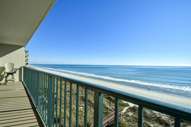 balcony featuring a beach view and a water view