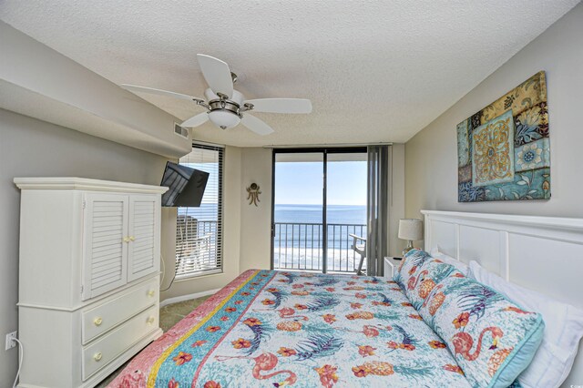 3601 S Ocean Blvd Unit 7-E, North Myrtle Beach, SC 29582 - carpeted bedroom featuring access to exterior, a textured ceiling, and ceiling fan
