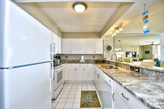 kitchen featuring a textured ceiling, white cabinetry, sink, and white appliances