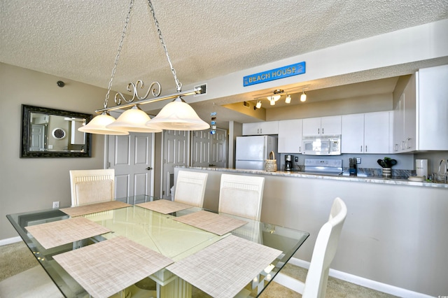3601 S Ocean Blvd Unit 7-E, North Myrtle Beach, SC 29582 - dining room with a textured ceiling and carpet