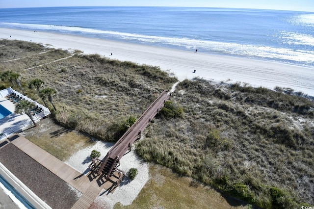 drone / aerial view with a water view and a beach view