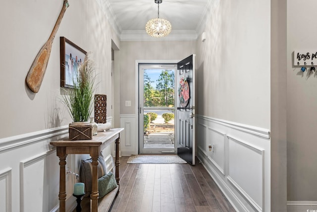 entryway with crown molding, dark hardwood / wood-style floors, and a notable chandelier