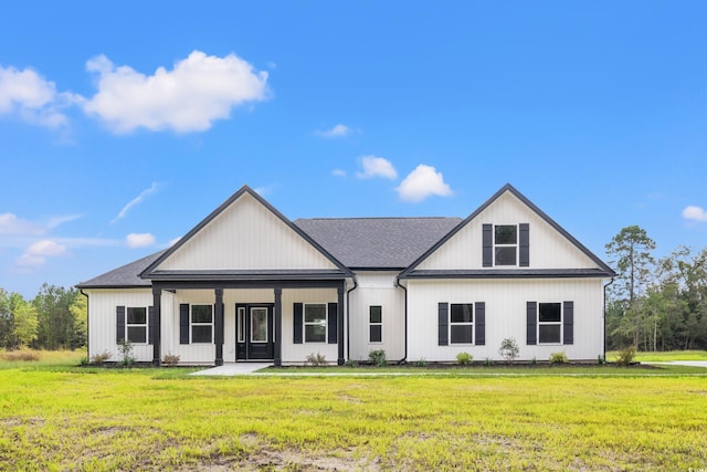 modern inspired farmhouse featuring a porch and a front yard