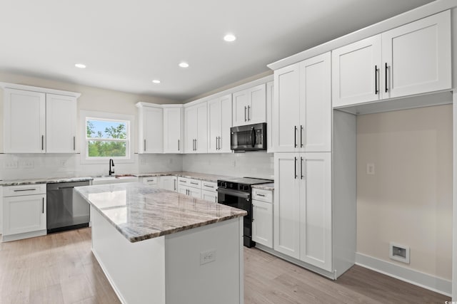 kitchen with white cabinets, a center island, and appliances with stainless steel finishes