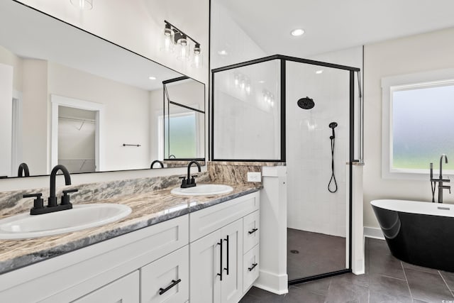 bathroom with tile patterned flooring, plenty of natural light, vanity, and shower with separate bathtub