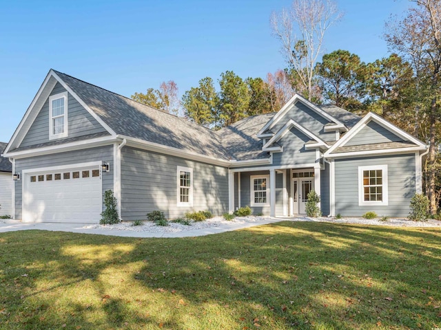 craftsman house featuring a garage and a front lawn