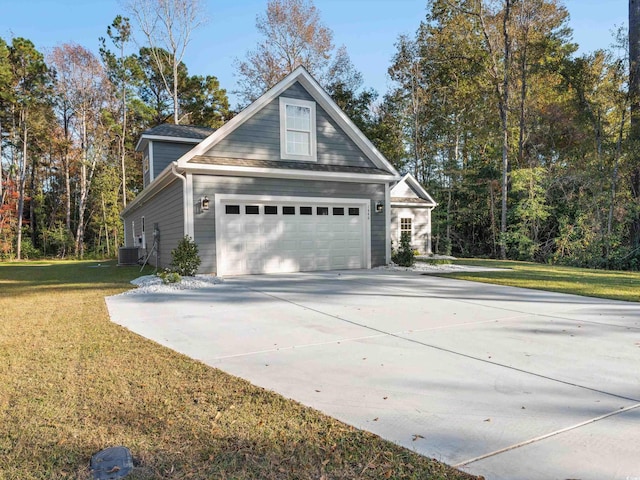 view of side of property with a yard and central AC