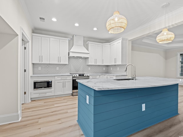 kitchen featuring white cabinets, appliances with stainless steel finishes, pendant lighting, and custom exhaust hood