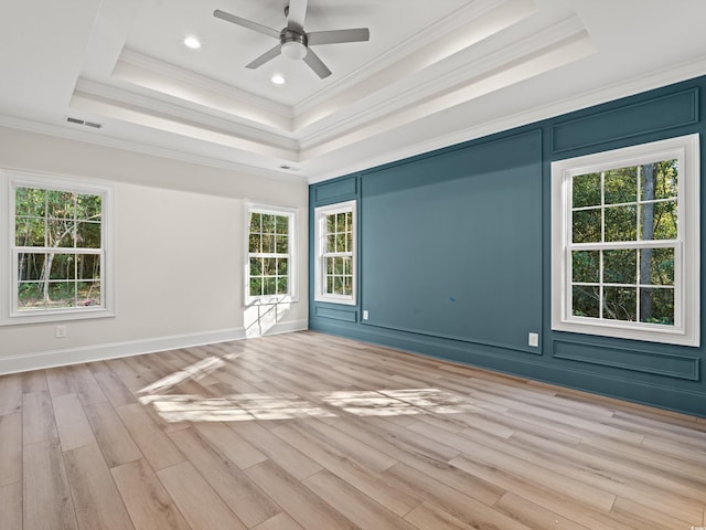 unfurnished room featuring a tray ceiling, crown molding, and ceiling fan