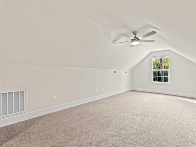 additional living space featuring carpet flooring, ceiling fan, and vaulted ceiling