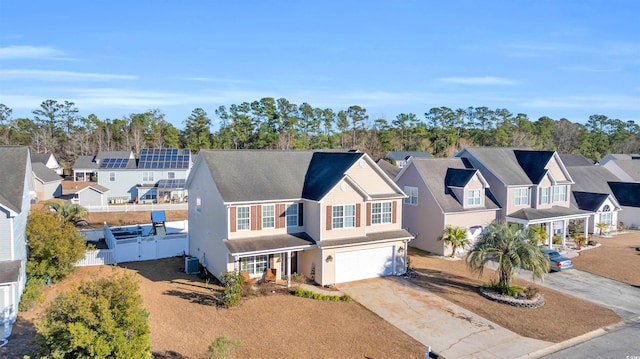 view of front of house with a garage and central air condition unit