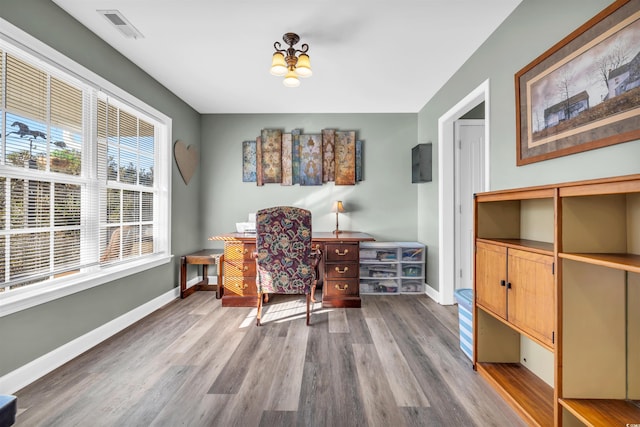 office area featuring wood-type flooring and a notable chandelier