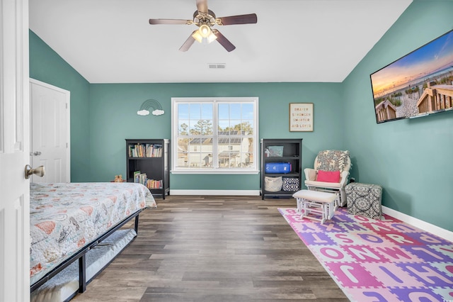 bedroom with ceiling fan, dark hardwood / wood-style flooring, and lofted ceiling