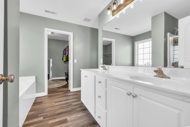 bathroom featuring vanity, a bathtub, and hardwood / wood-style floors