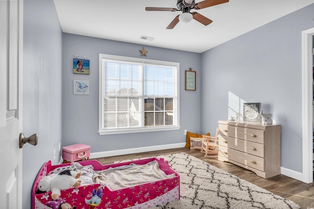 bedroom featuring ceiling fan and dark hardwood / wood-style floors