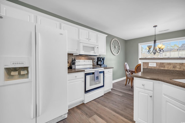 kitchen featuring a chandelier, white cabinets, decorative light fixtures, and white appliances