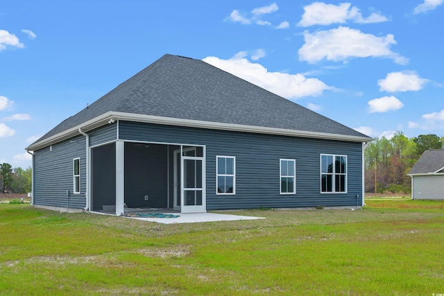 back of property featuring a lawn and a patio