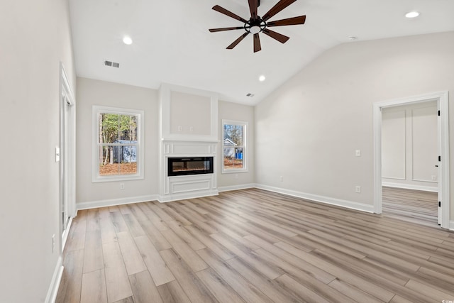 unfurnished living room with light hardwood / wood-style flooring, ceiling fan, and lofted ceiling