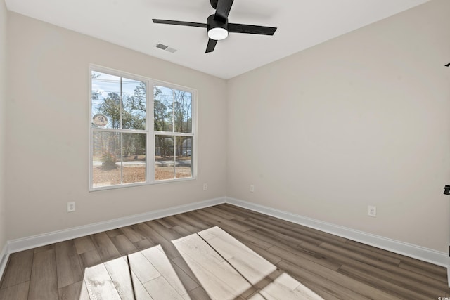 spare room with hardwood / wood-style flooring and ceiling fan