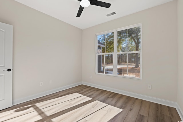 unfurnished room with ceiling fan and wood-type flooring