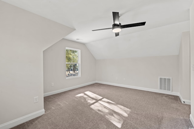 additional living space featuring carpet, vaulted ceiling, and ceiling fan