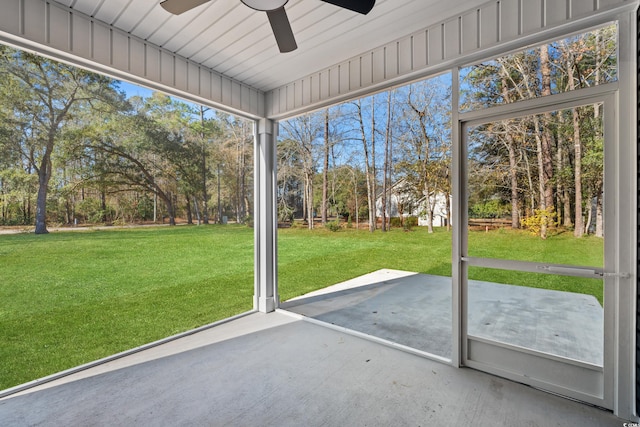 unfurnished sunroom featuring ceiling fan