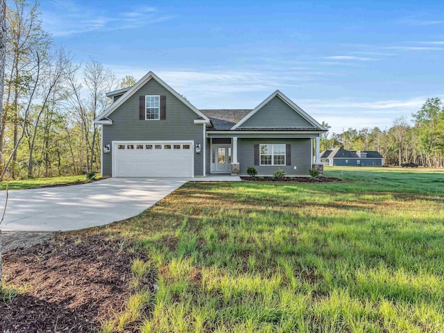 view of front of house with a front yard and a garage