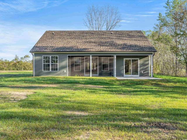 rear view of house featuring a yard