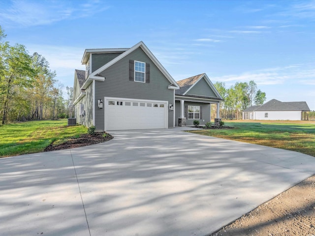 view of front property featuring a front yard, a garage, and cooling unit