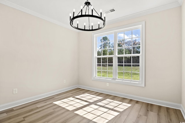 unfurnished dining area with ornamental molding, light wood-type flooring, and a notable chandelier