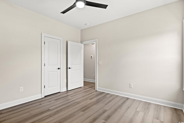 unfurnished bedroom featuring ceiling fan and light wood-type flooring