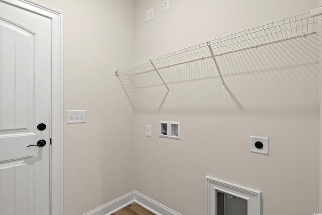 washroom with hookup for an electric dryer, washer hookup, and wood-type flooring