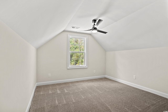 additional living space featuring ceiling fan, carpet floors, and vaulted ceiling