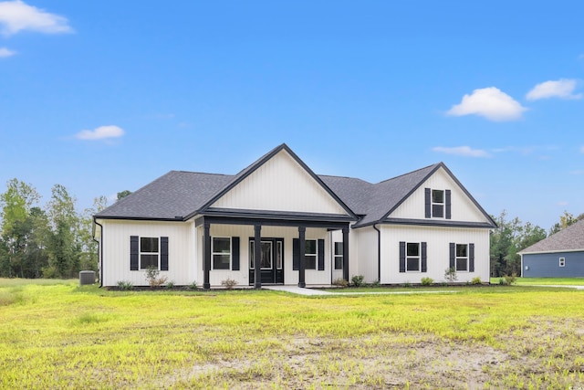 modern farmhouse with central AC unit, covered porch, and a front yard