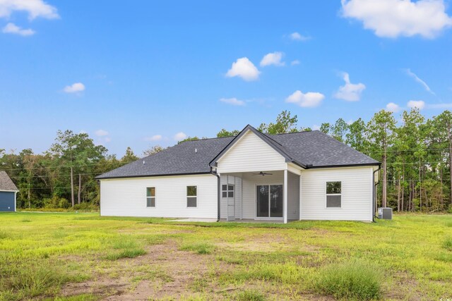 rear view of house with a yard, a garage, and a sunroom