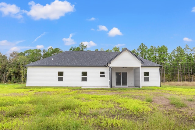 back of house featuring a lawn and ceiling fan