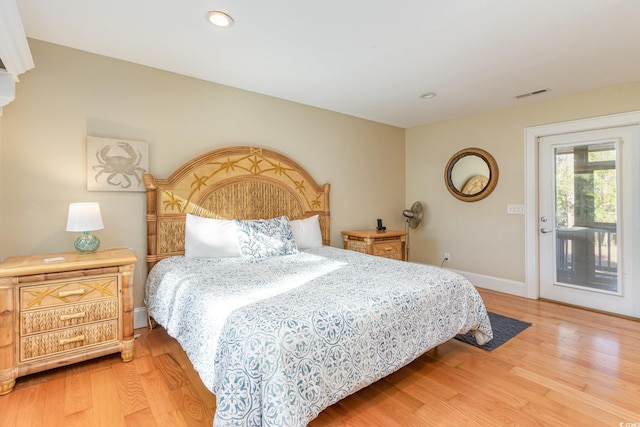 bedroom featuring access to exterior and wood-type flooring