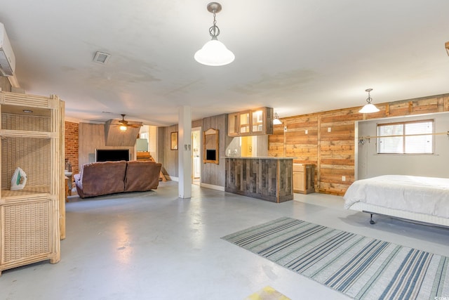 bedroom with wooden walls and concrete flooring