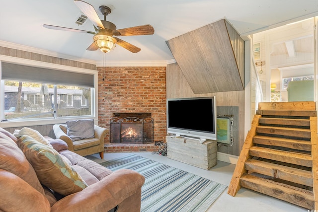 living room with a fireplace, ceiling fan, and ornamental molding