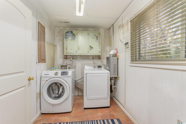 laundry room with light tile patterned flooring, cabinets, and separate washer and dryer