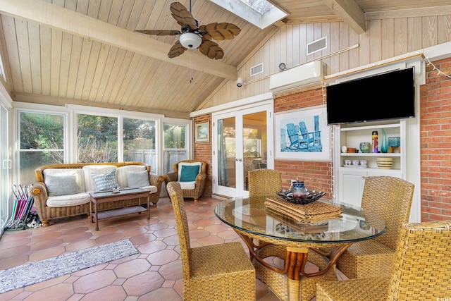 sunroom featuring french doors, lofted ceiling with skylight, ceiling fan, and wood ceiling