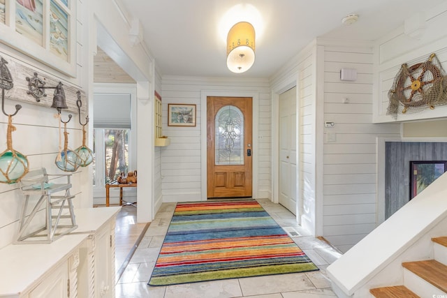 tiled entryway with wooden walls